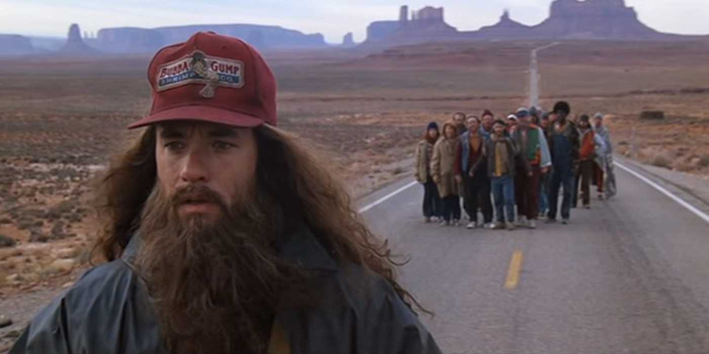 A lone figure stops running on an empty desert highway as a long line of people trails behind.